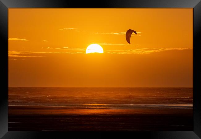 Kitesurfing at Sunset Framed Print by Roger Green
