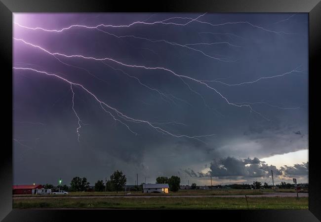 Forked Lightning Over a Montana Post Office, USA.  Framed Print by John Finney