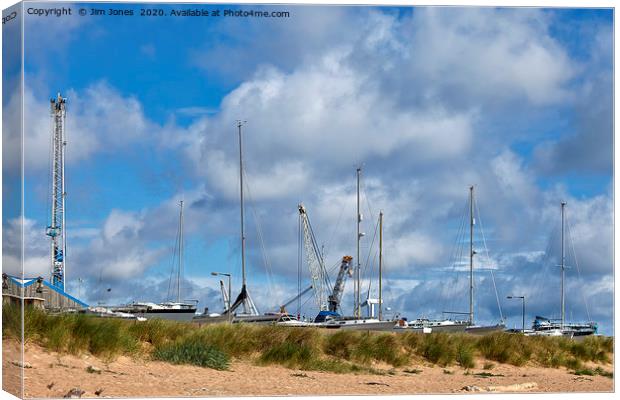 Yachts and Cranes behind the dunes Canvas Print by Jim Jones