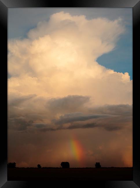 Cumulus storm cloud and rainbow Framed Print by Simon Johnson