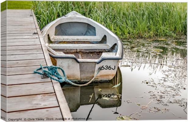 Boat tied to wooden staging on the Norfolk Broads Canvas Print by Chris Yaxley
