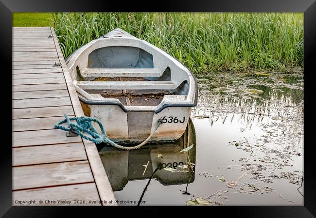 Boat tied to wooden staging on the Norfolk Broads Framed Print by Chris Yaxley