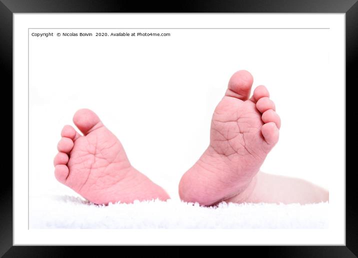 Newborn feet close up on white background. Baby bo Framed Mounted Print by Nicolas Boivin