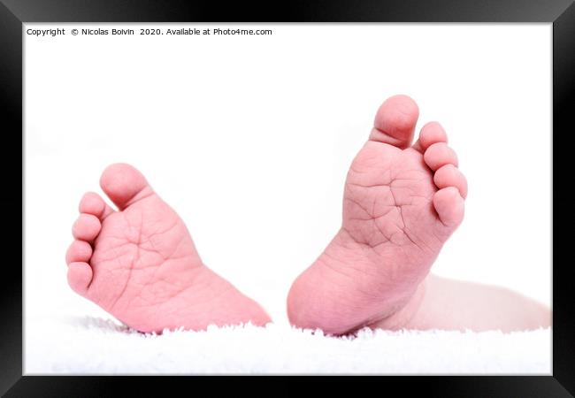 Newborn feet close up on white background. Baby bo Framed Print by Nicolas Boivin