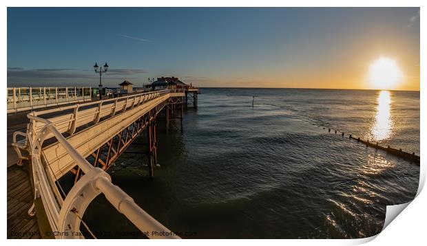 Fisheye view along Cromer Pier at sunrise Print by Chris Yaxley