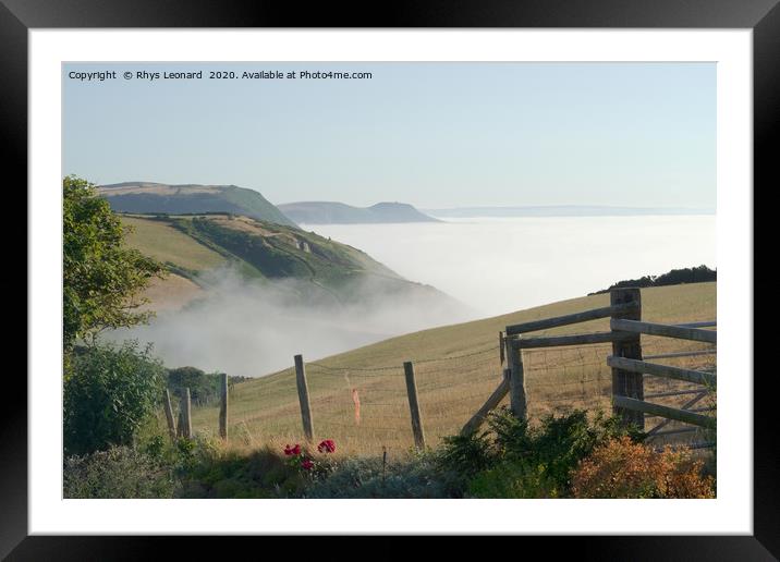 Sea mist rises from under green cliffs Framed Mounted Print by Rhys Leonard