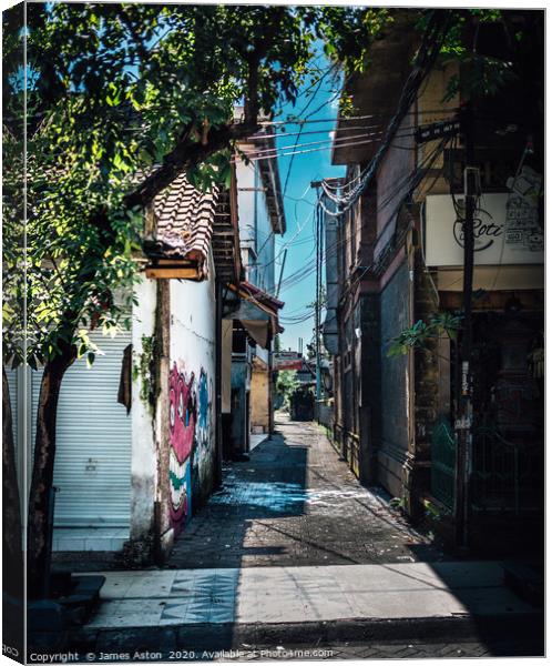 An Urban Side Street in Bali Canvas Print by James Aston