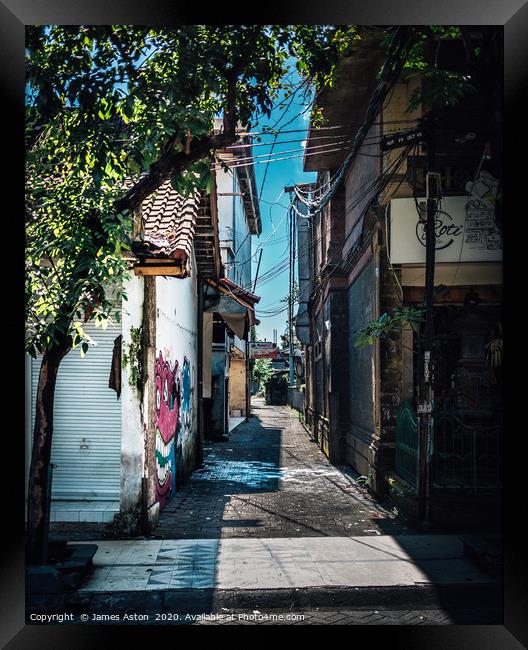 An Urban Side Street in Bali Framed Print by James Aston