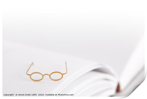 Tiny reading glasses on open book Print by Simon Bratt LRPS