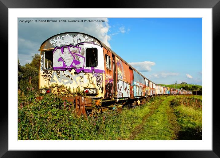 Derelict railway carriages covered in graffiti. Framed Mounted Print by David Birchall