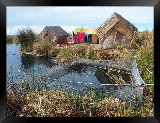 Traditional huts on Uros floating islands Framed Print by Theo Spanellis