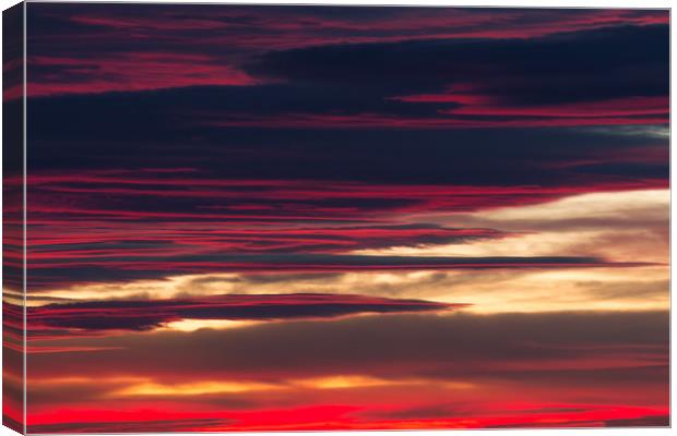 Red clouds in a sunset light Canvas Print by Arpad Radoczy