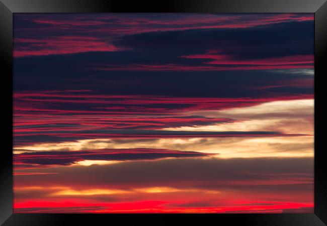 Red clouds in a sunset light Framed Print by Arpad Radoczy