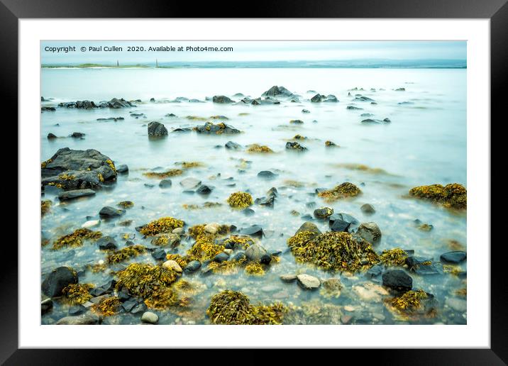 Rocks and Seaweed Uncovered at Lindisfarne. Framed Mounted Print by Paul Cullen