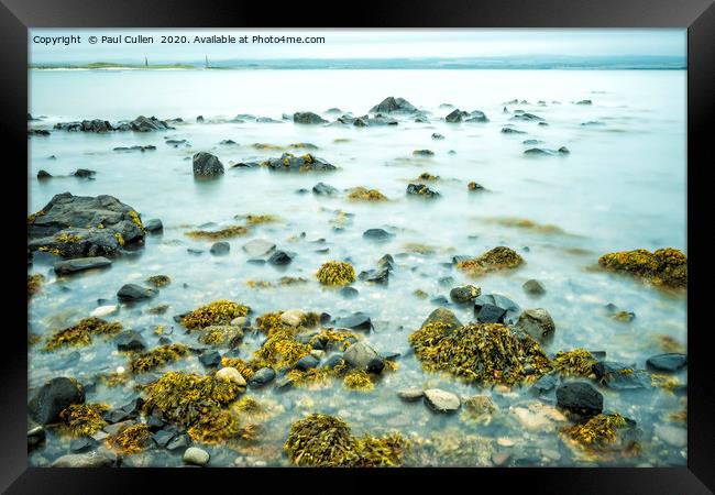 Rocks and Seaweed Uncovered at Lindisfarne. Framed Print by Paul Cullen