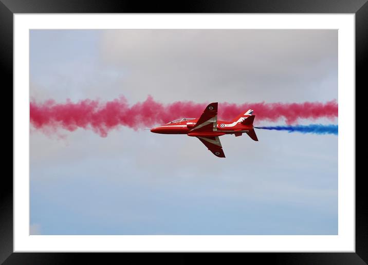 Red Arrows through blue and red smoke Framed Mounted Print by Simon Marlow