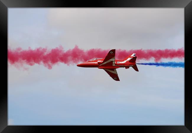 Red Arrows through blue and red smoke Framed Print by Simon Marlow