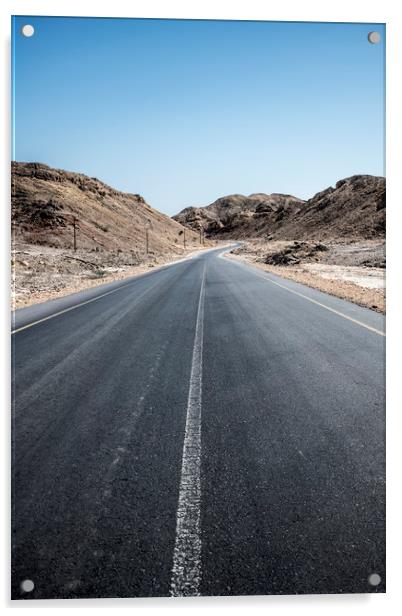 An empty tarmac road going thru arid mountains in  Acrylic by David GABIS