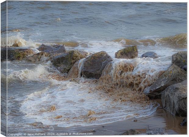 Waves Splashing over the Rocks Canvas Print by Jane Metters