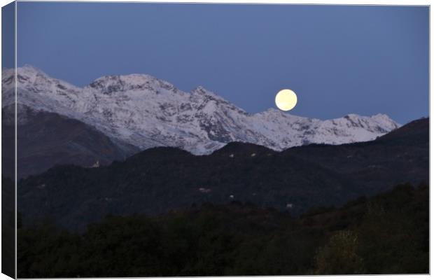 Moon setting behind the mountains before sunrise Canvas Print by Fabrizio Malisan