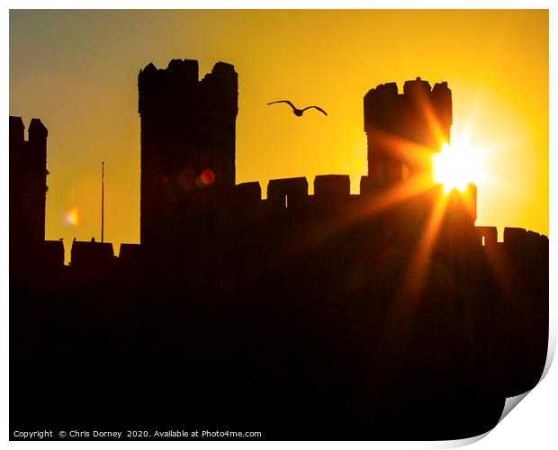 Caernarfon Castle at Sunset in North Wales, UK Print by Chris Dorney