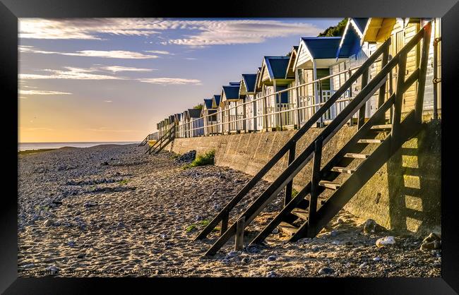 Cromer beach huts at sunrise Framed Print by Chris Yaxley