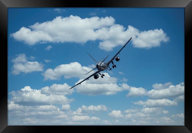 Passenger airplane on a cloudy sky Framed Print by Arpad Radoczy