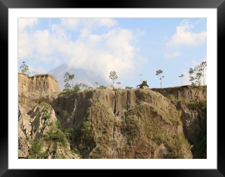 Light brown rugged steep hill in front of a Vulcan Framed Mounted Print by Hanif Setiawan