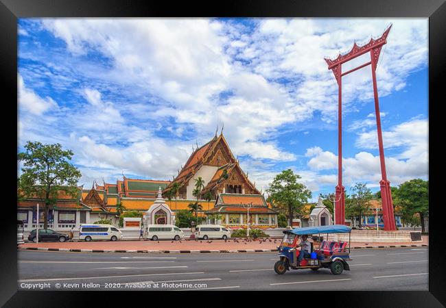 A tuk tuk drives past the Giant Swing Framed Print by Kevin Hellon