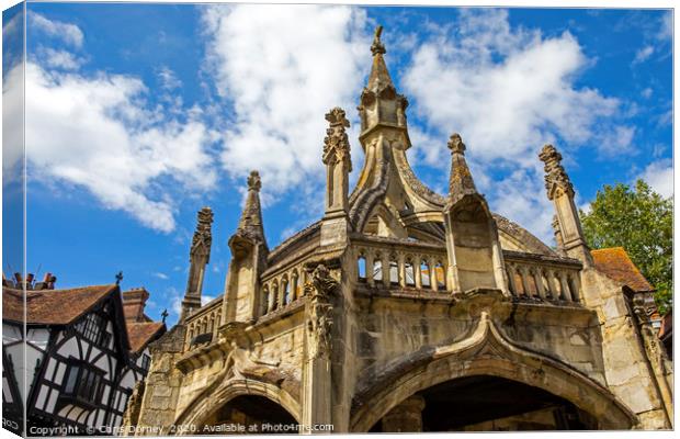 Poultry Cross and Traditional Timber-Framed Buildi Canvas Print by Chris Dorney