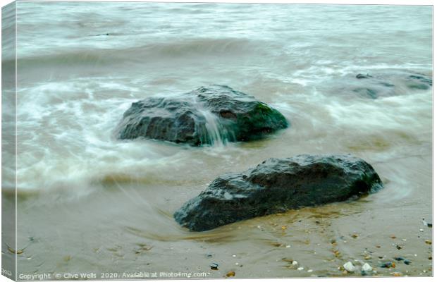 Incoming tide on the rocks at Old Hunstanton Canvas Print by Clive Wells