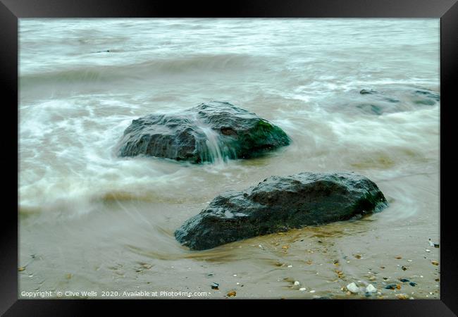 Incoming tide on the rocks at Old Hunstanton Framed Print by Clive Wells
