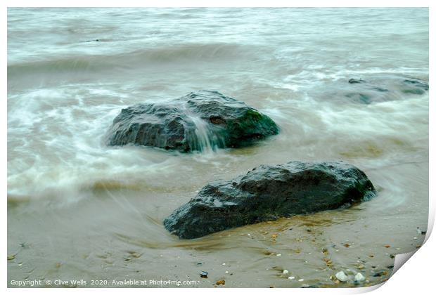 Incoming tide on the rocks at Old Hunstanton Print by Clive Wells