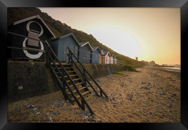 Sunset over Cromer beach huts Framed Print by Christopher Keeley