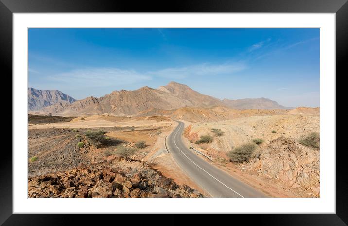 A road going thru the deserted mountains of Oman Framed Mounted Print by David GABIS