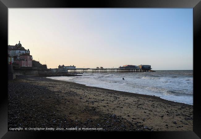 Cromer pier and beach at golden hour Framed Print by Christopher Keeley