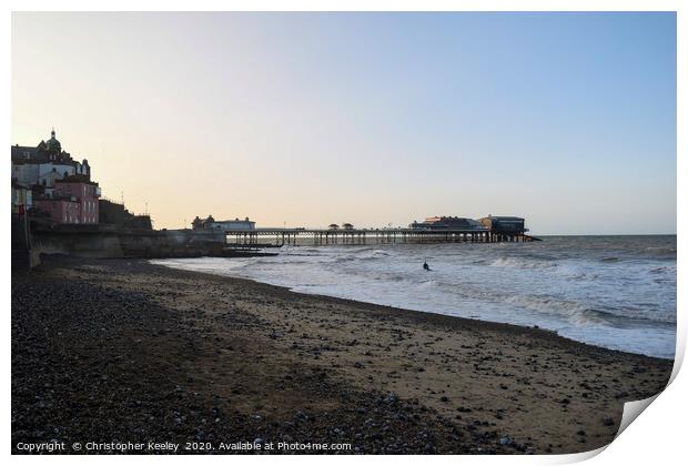 Cromer pier and beach at golden hour Print by Christopher Keeley