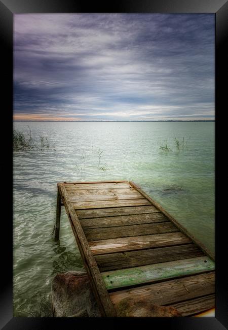 Wooden pier in lake Balaton of Hungary in a cloudy Framed Print by Arpad Radoczy
