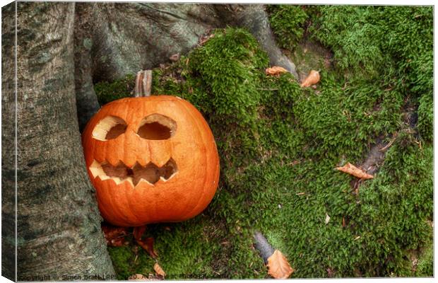 Scary halloween pumpkin in the woods Canvas Print by Simon Bratt LRPS