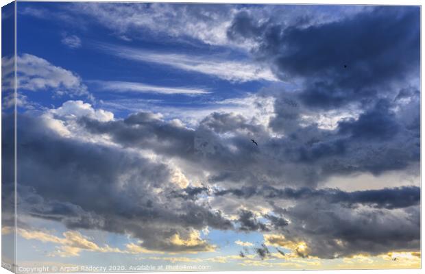 Nice clouds after a storm with sunset light Canvas Print by Arpad Radoczy