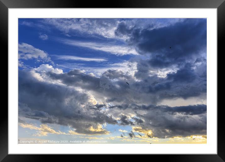 Nice clouds after a storm with sunset light Framed Mounted Print by Arpad Radoczy
