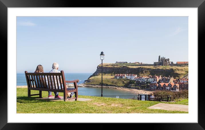 Couple on a bench overlooking Whitby harbour Framed Mounted Print by Jason Wells