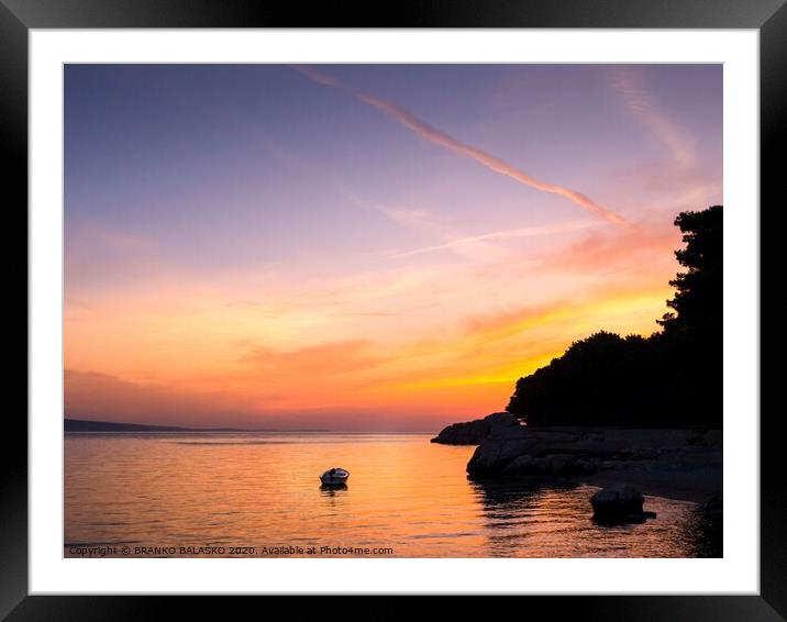A sunset over a body of water Framed Mounted Print by BRANKO BALAŠKO