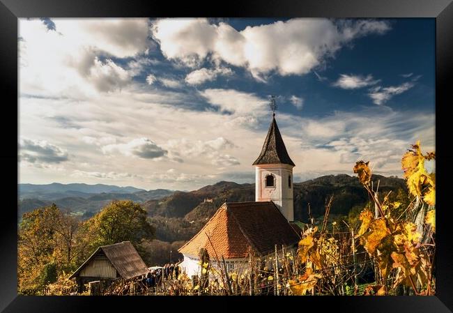 A church with a mountain in the background Framed Print by BRANKO BALAŠKO