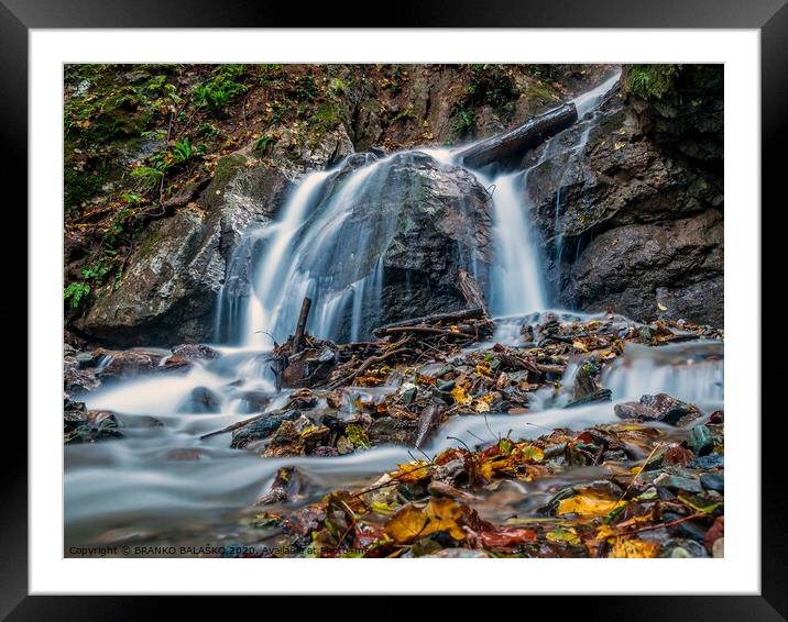 A large waterfall over some water Framed Mounted Print by BRANKO BALAŠKO