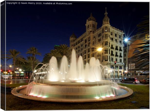 A fountain lit up at night, Alicante, Spain Canvas Print by Navin Mistry