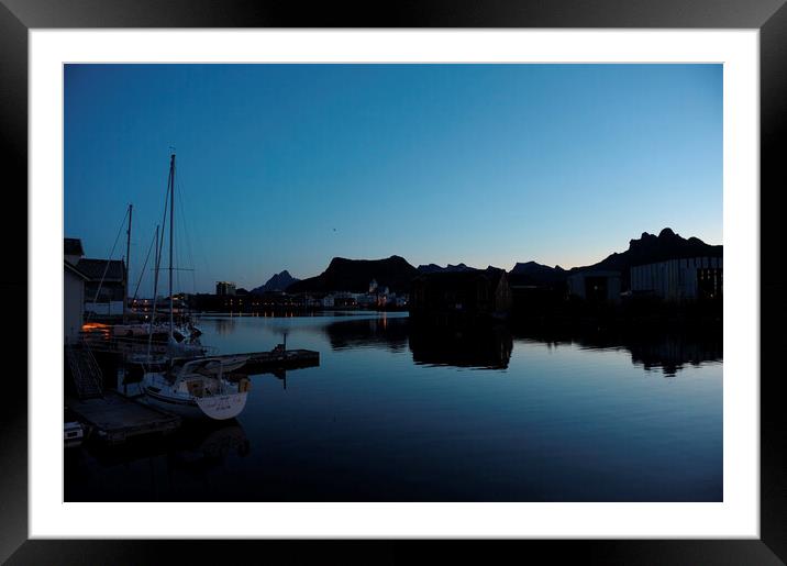 A boat is docked in a harbor at the blue hour, in a fjord Framed Mounted Print by Alessandro Della Torre