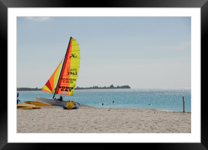 A boat sitting on top of a sandy beach next to the ocean Framed Mounted Print by Alessandro Della Torre