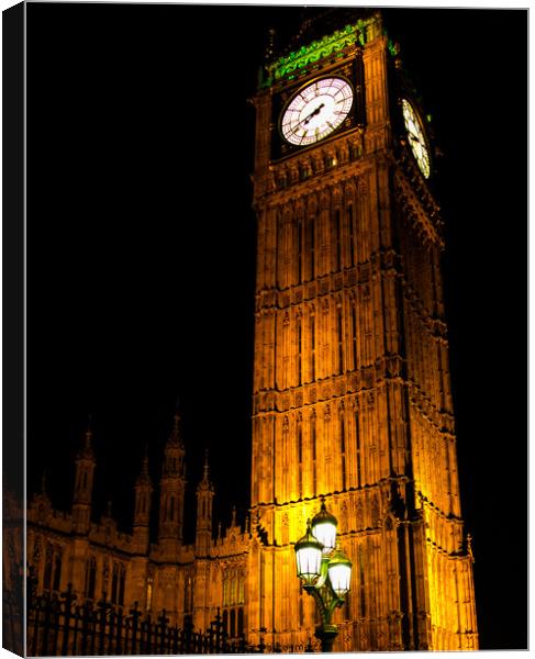 A clock tower lit up at night Canvas Print by henry harrison