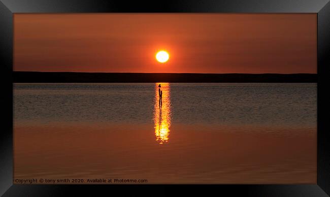 A sunset over a body of water Framed Print by tony smith